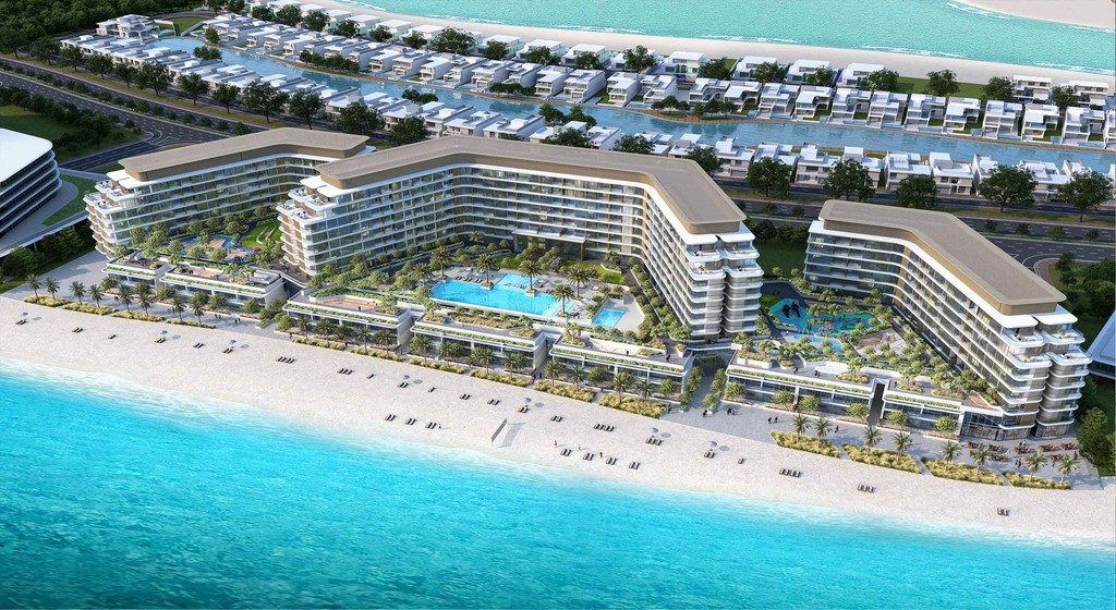 A scenic view of Delphine Beach resort in Dubai, showcasing palm trees, sandy shores, and clear blue waters.