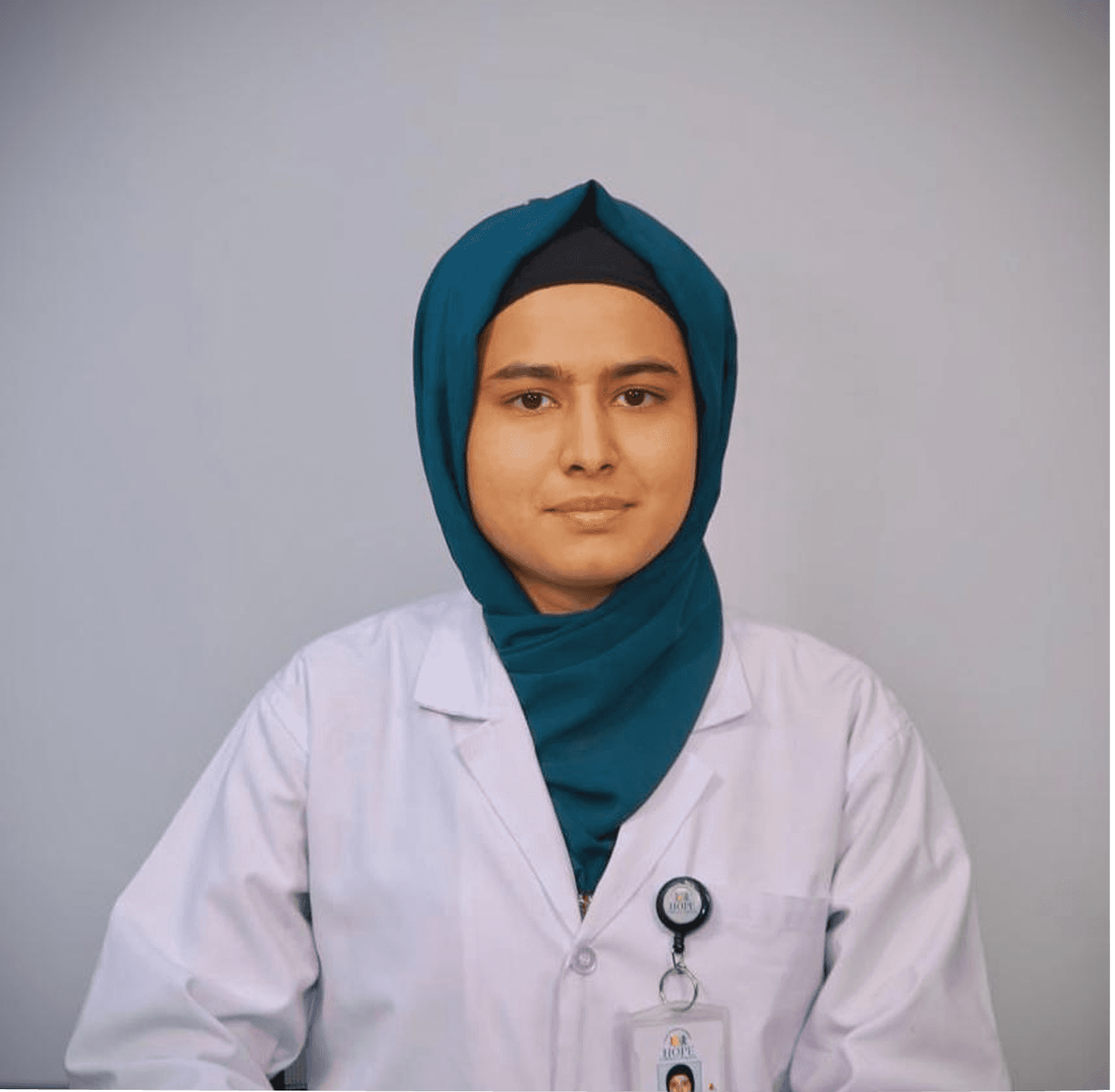 A businesswoman sitting at her desk, smiling and looking at the camera.