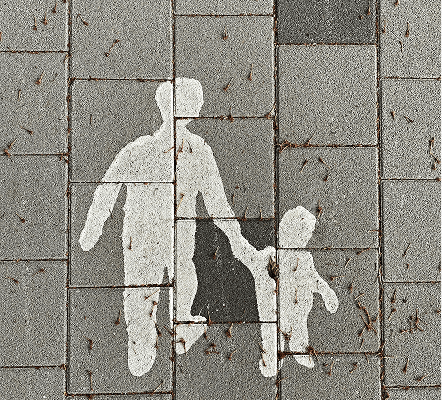 Woman walking on a wet street at night
