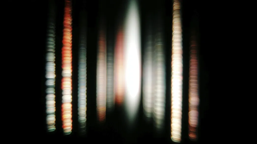 Several colorful beams of light and shadow in the darkness