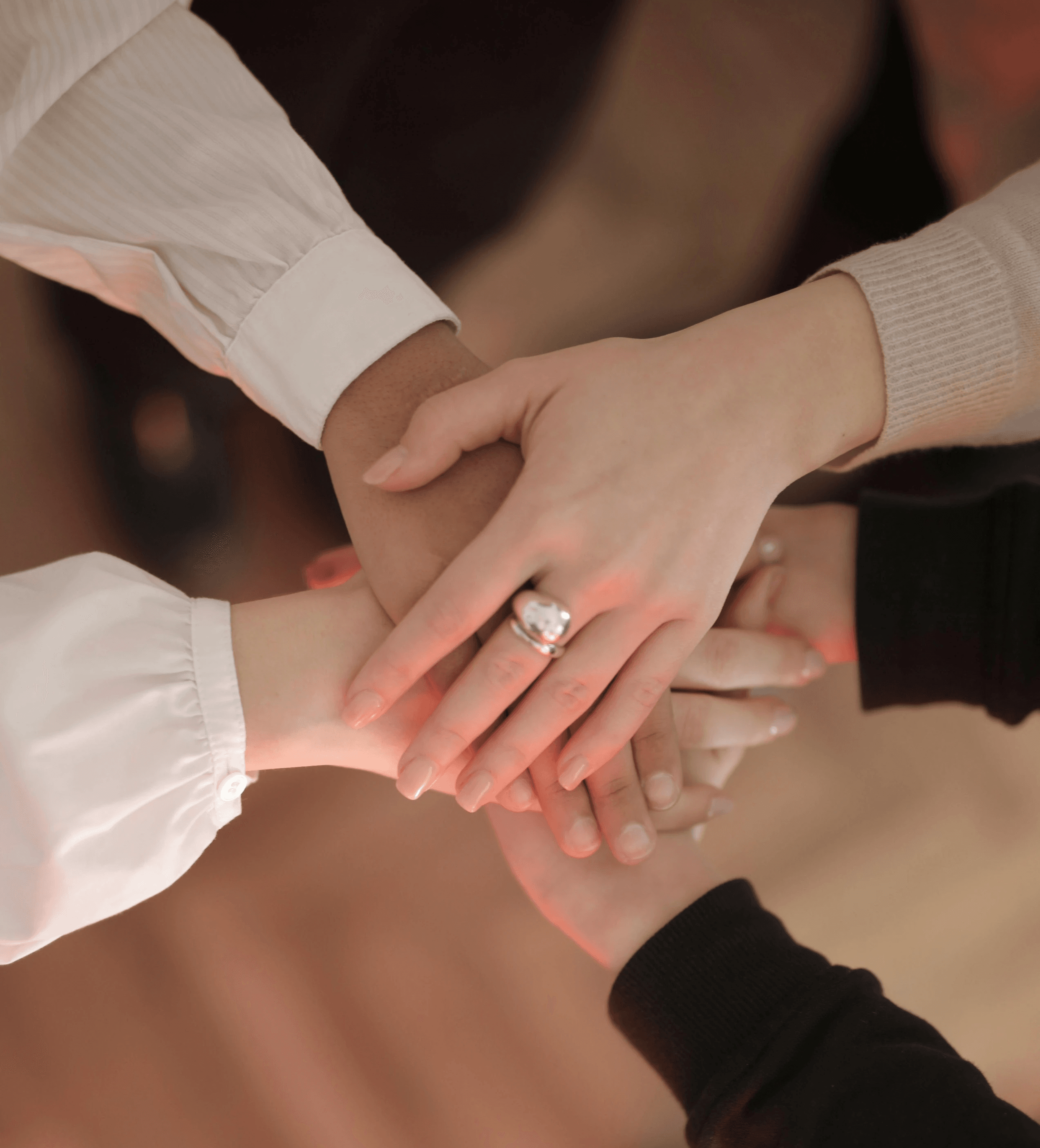 Four people holding hands. A symbol of unity and community