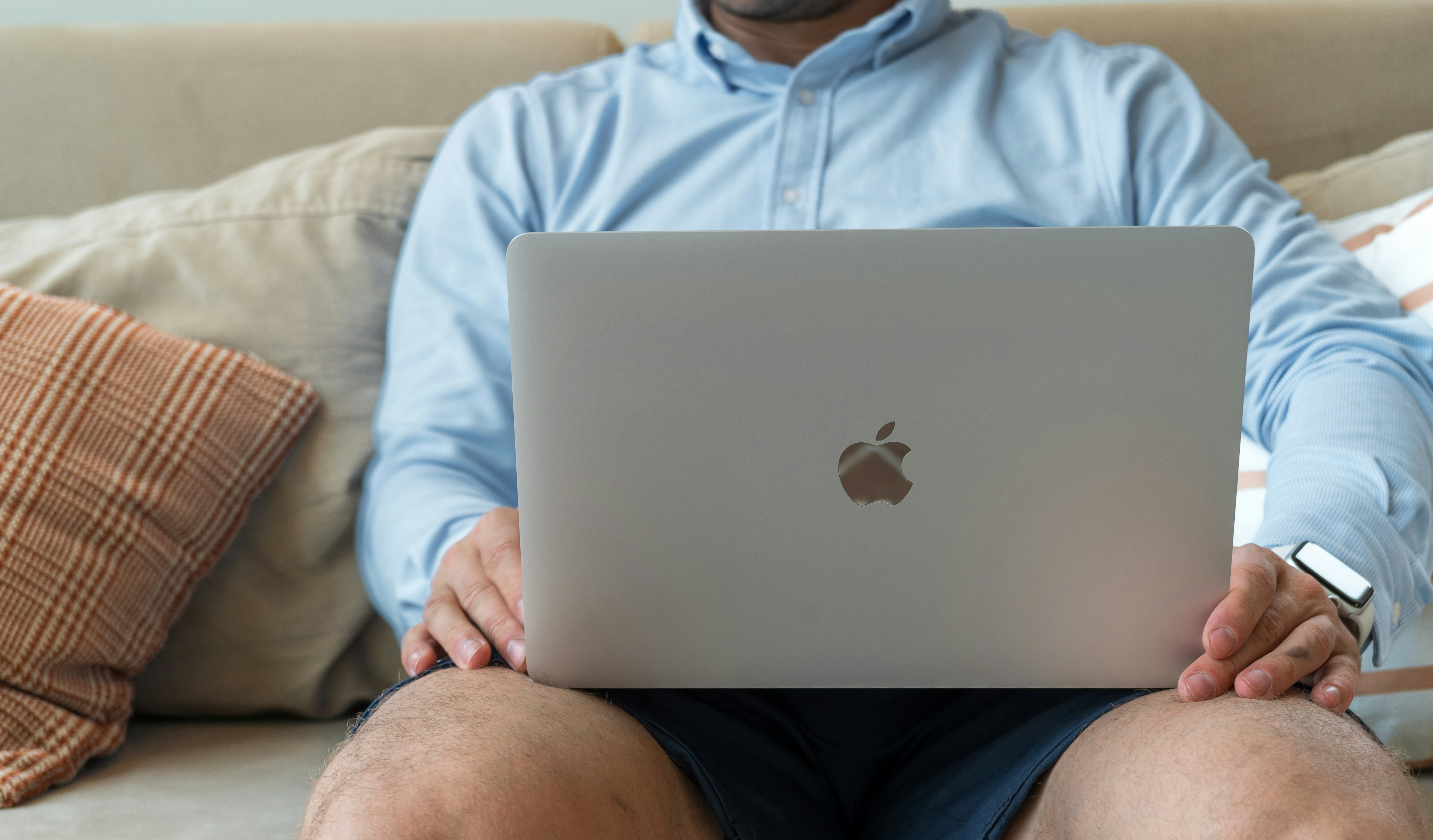 man sitting on couch - Copysmith Alternatives