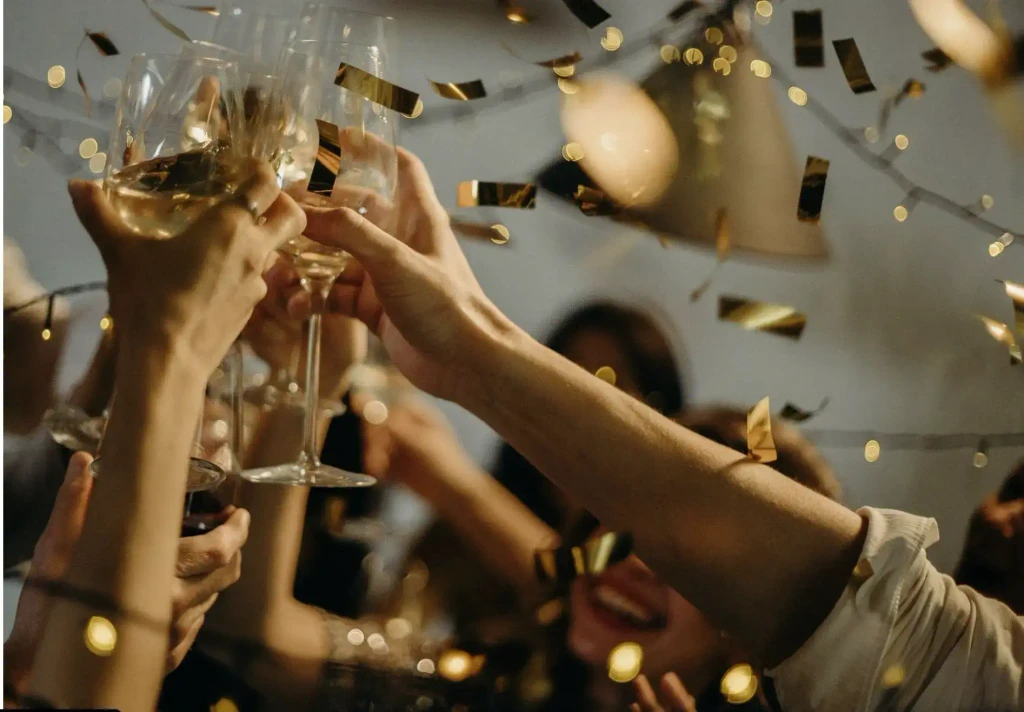 hands toasting champagne glasses at holiday party toast