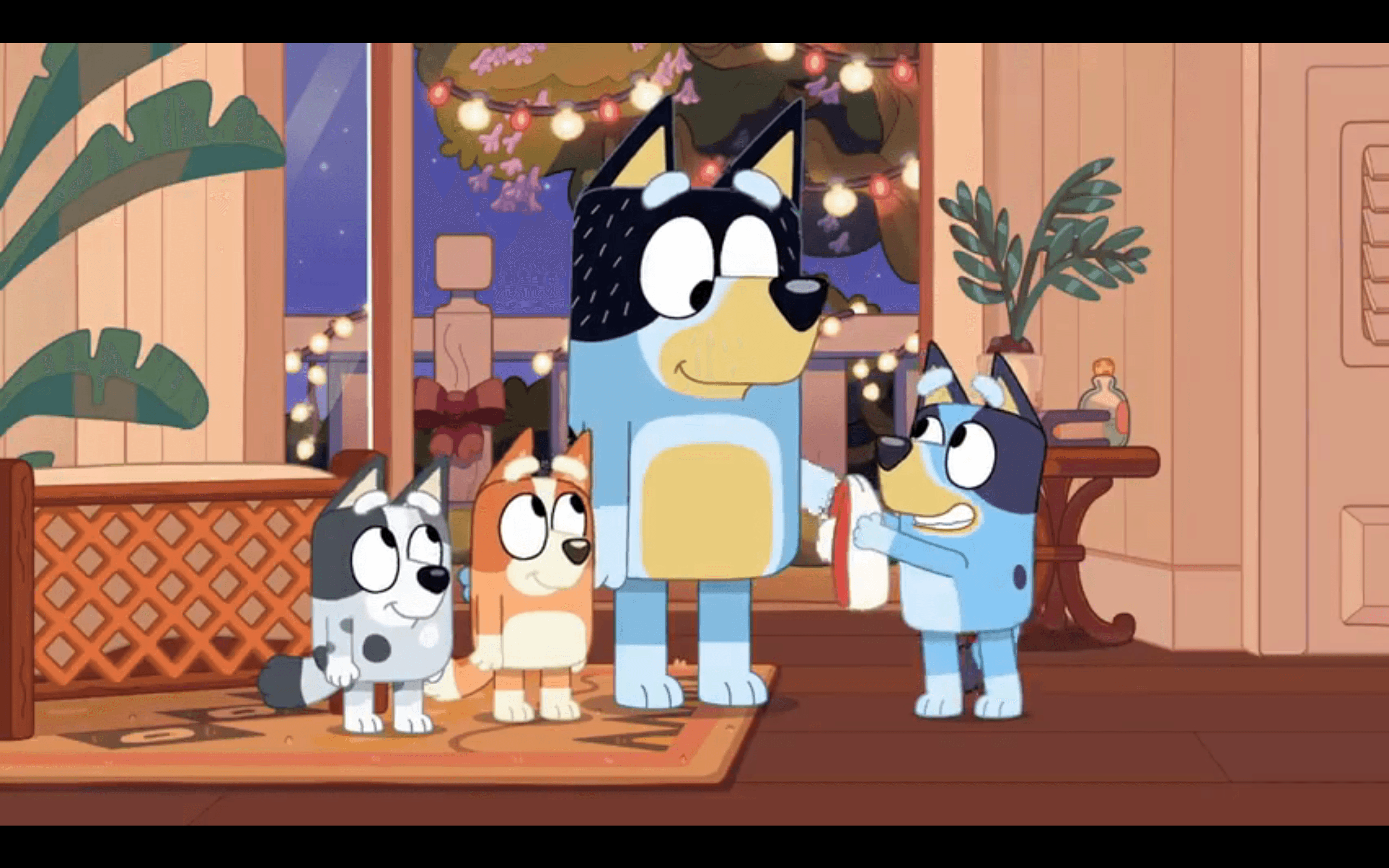 A cartoon family of anthromorphic dogs, a dad and three daughters, night, in a brightly lit room with tropical plants and Christmas lights.