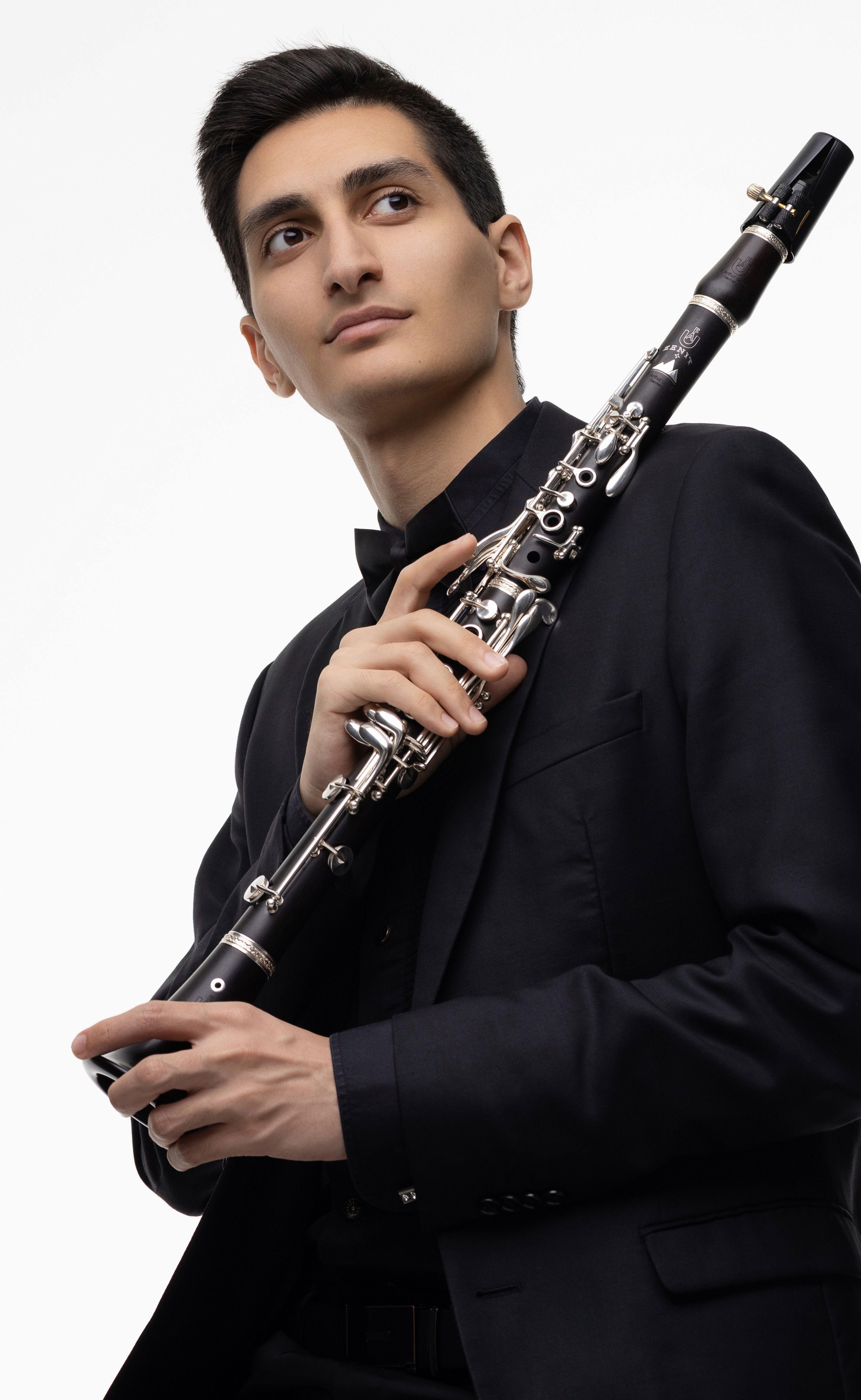 Erik Mirzoyan holding a clarinet in a studio portrait