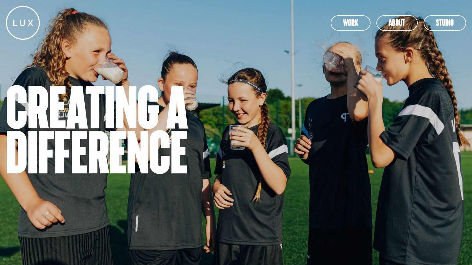 Two women enjoying food and drinks at a restaurant table, representing the work of LUX agency.