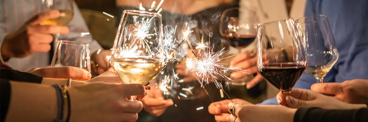 People with wine glasses and sparklers