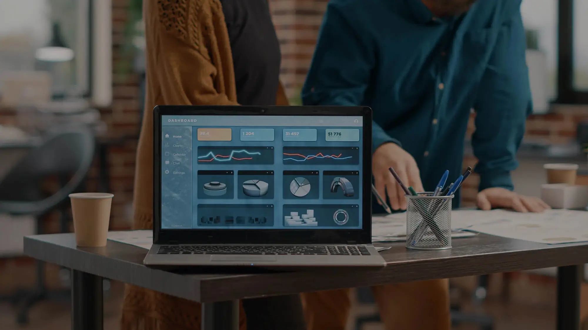 Laptop with data dashboard on office desk