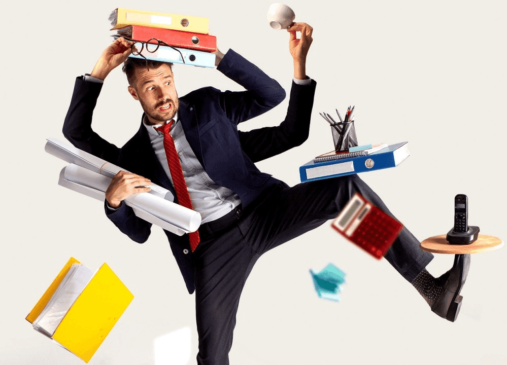 An image of a man struggling to handle all his tasks