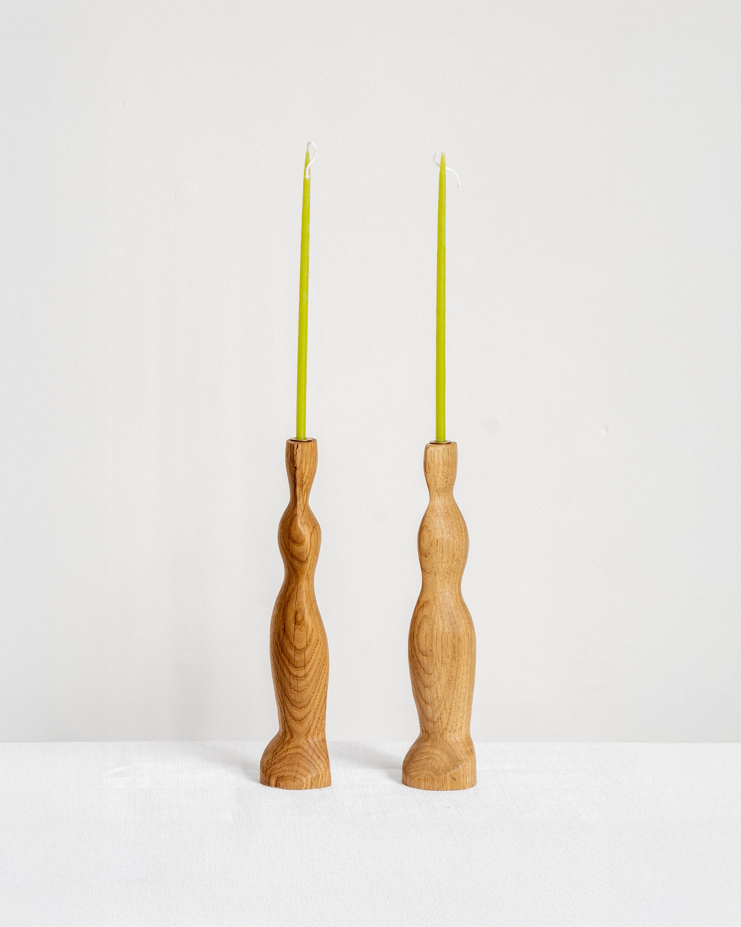 Figura Candlestick holders in Oak on white background with green candles