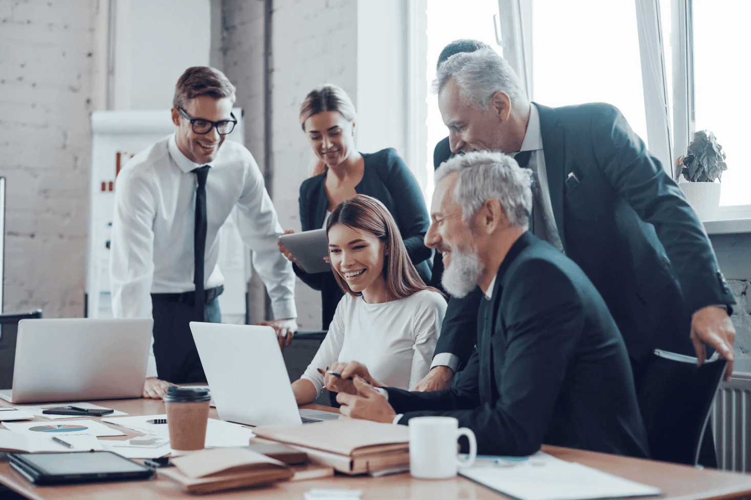 PPC team reviewing performance on a laptop, comparing manual Amazon Ads management with real-time automation in Q4.