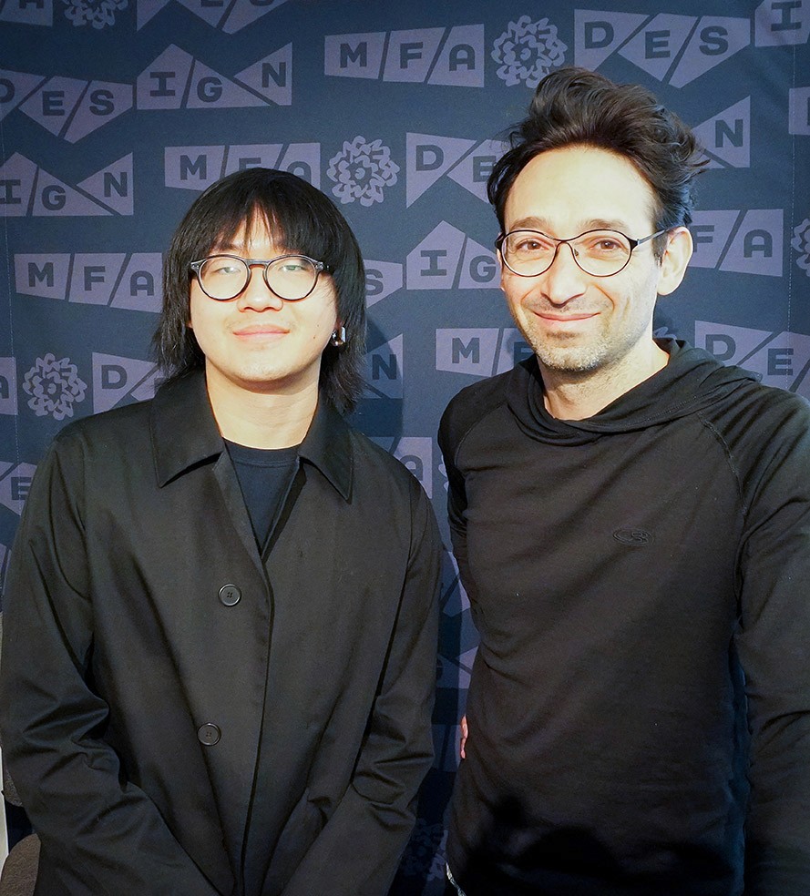 Portrait of two men dressed in black in front of a navy blue backdrop with the MFA design logo on it