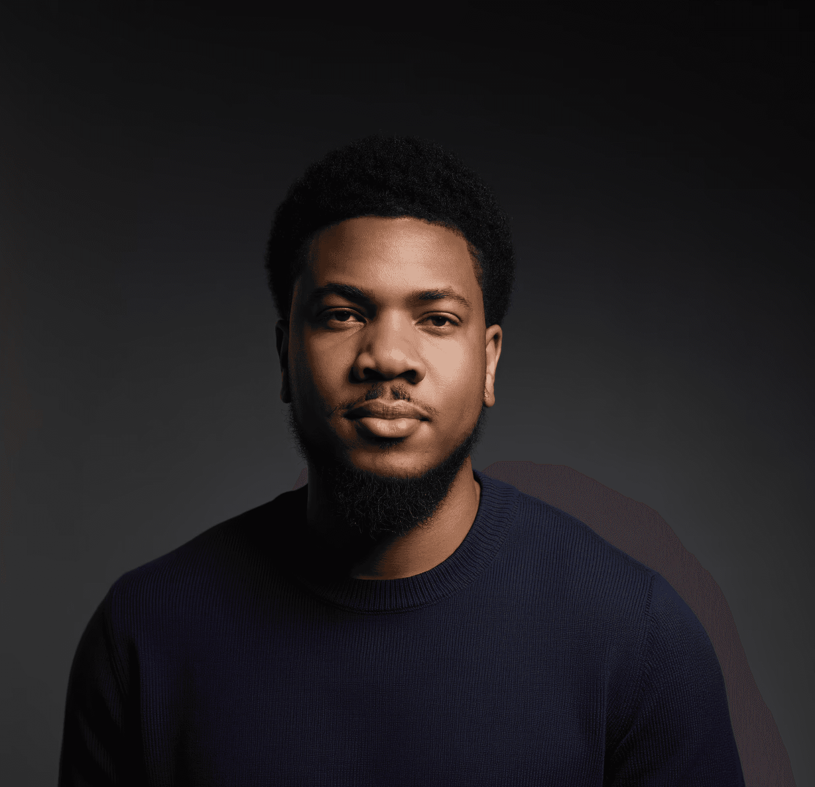 Young man in a blue shirt with a, against a plain background.