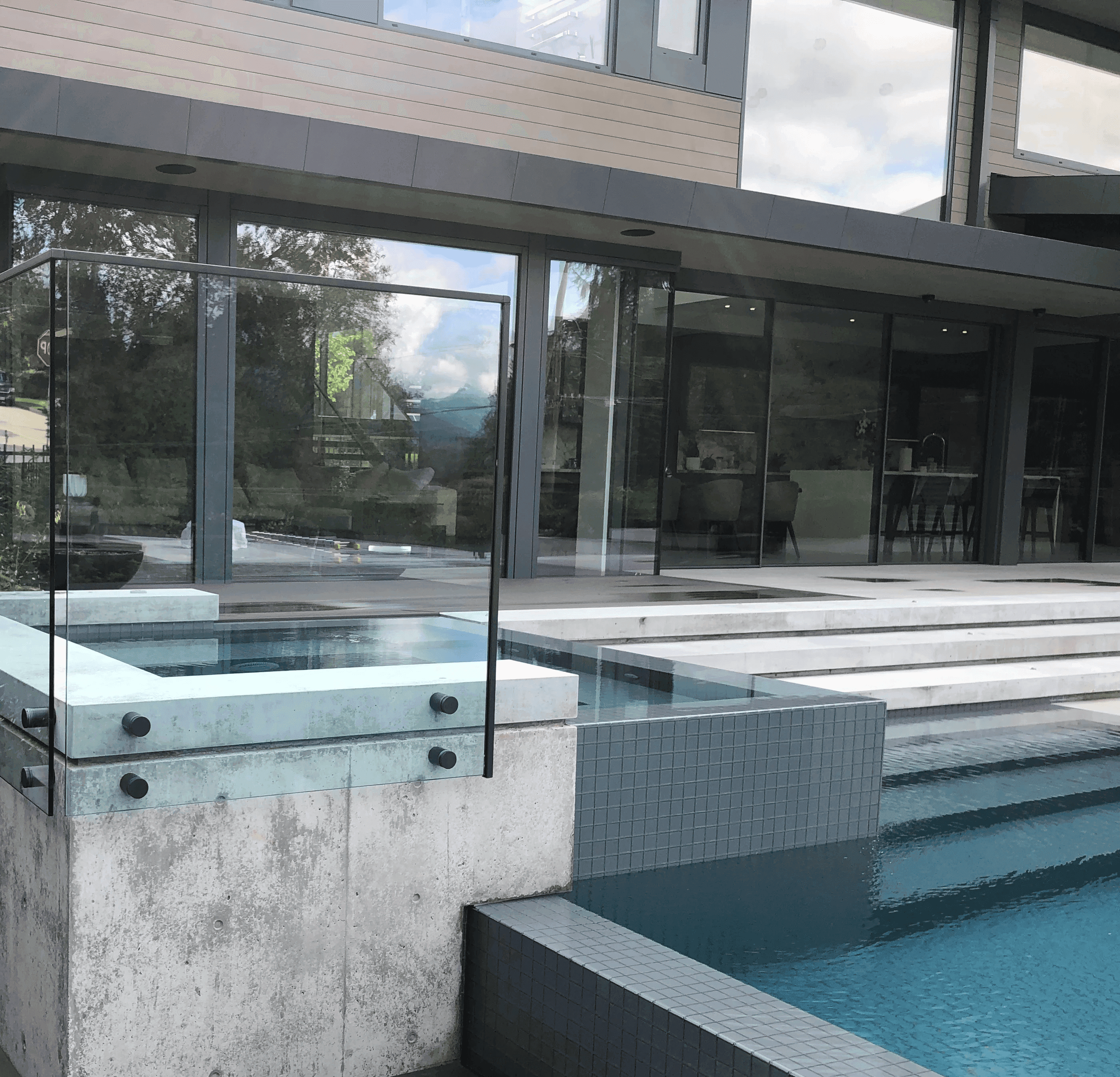 Glass pool fence on a multi-level pool.