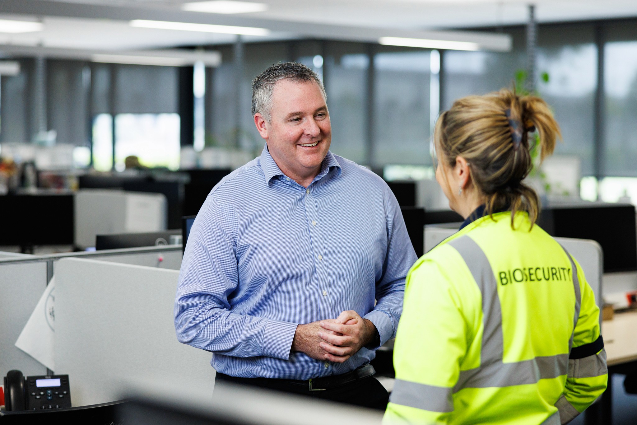 A man talks to a woman in an office