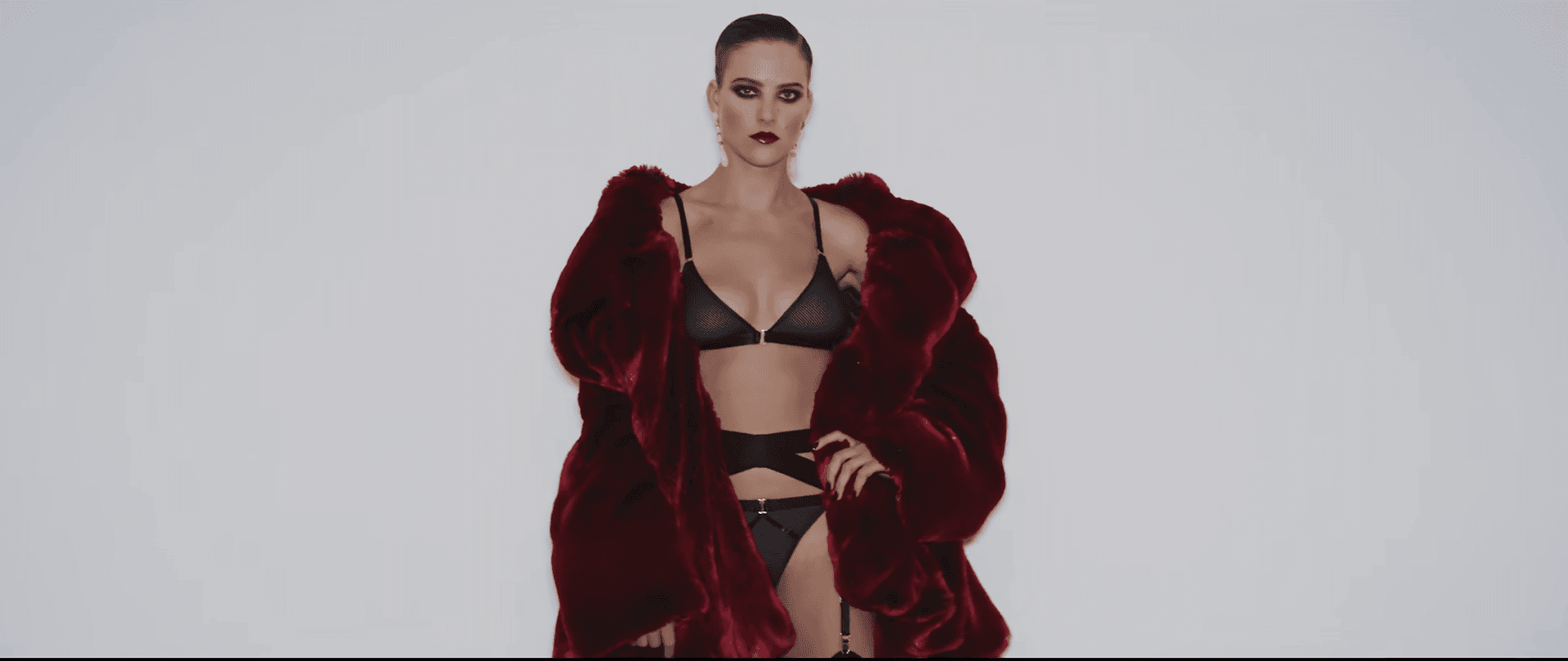 A person stands on steps with hair covering face.