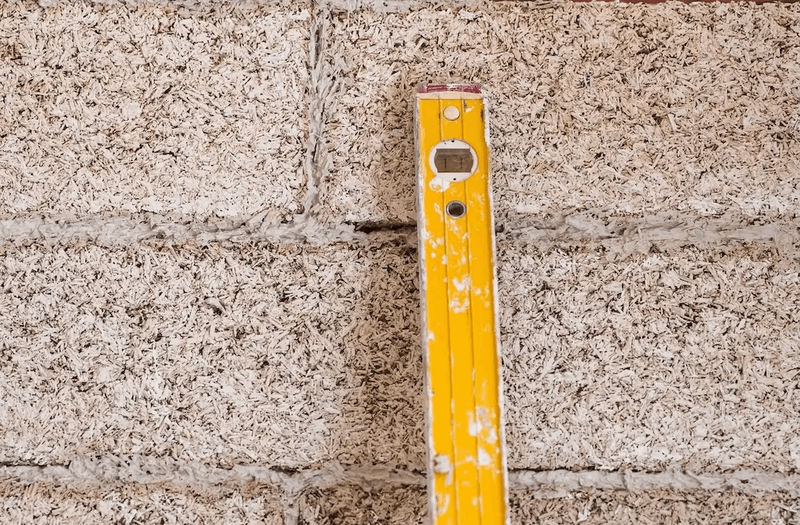 Hempcrete block wall showing a yellow level on the RespiraBlock 120mm