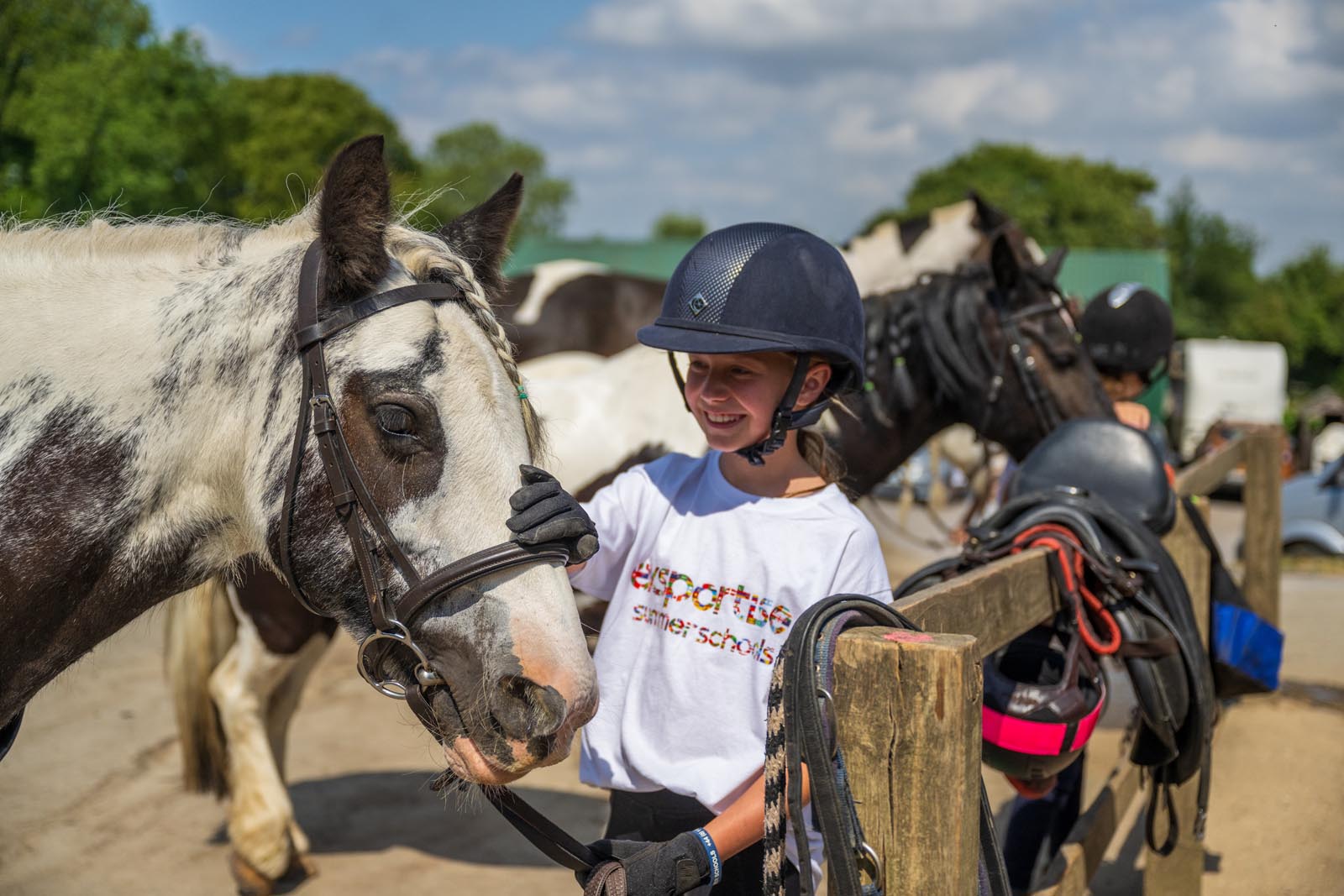 Student smiling at her horse.