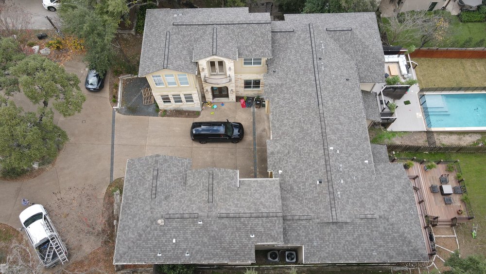 GAF architectural shingles with a ridge vent on a cross-hipped roof, offering a durable and well-ventilated roofing solution.