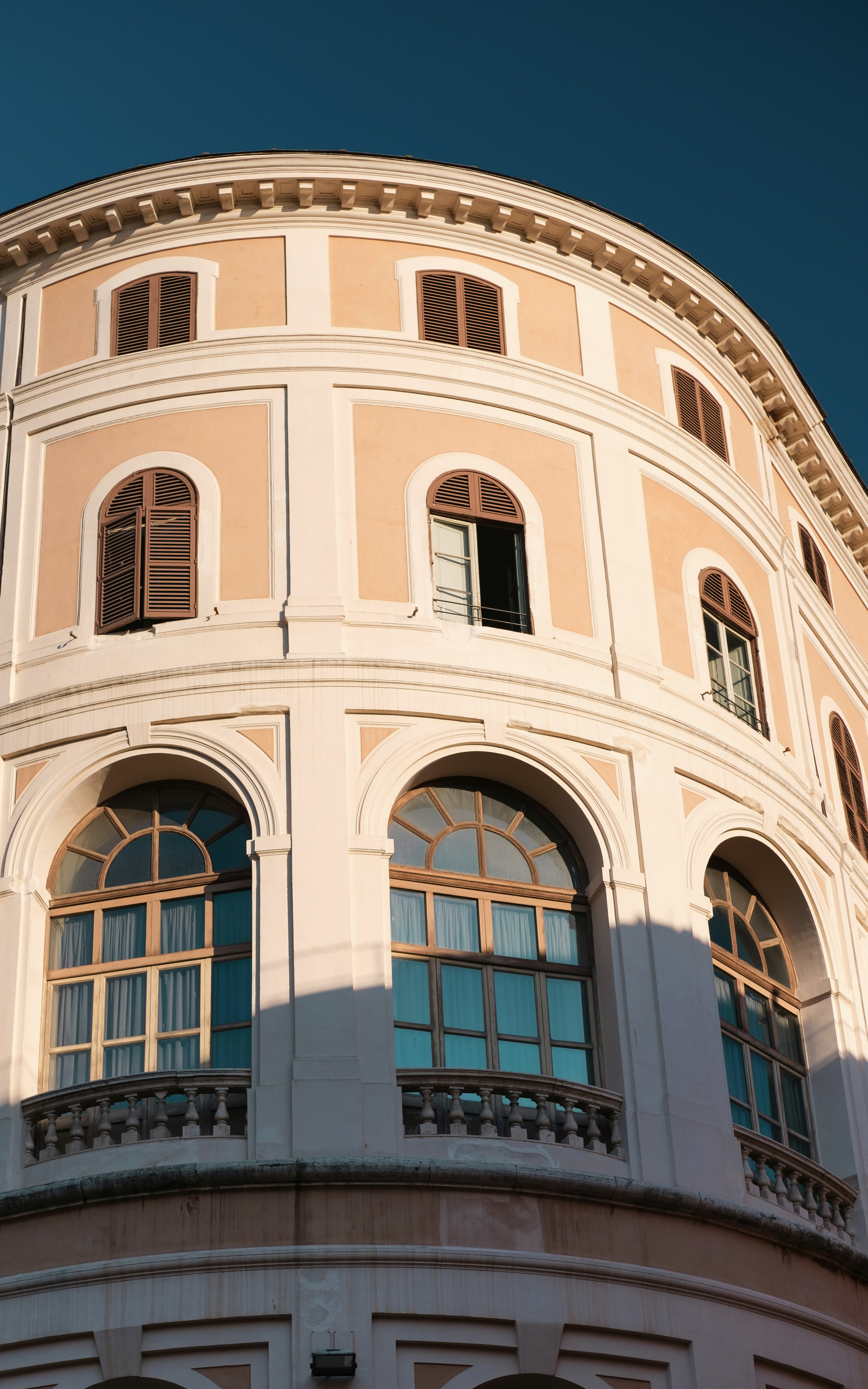 A curved building with arched windows.