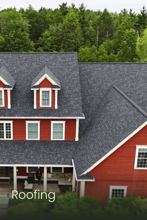 A smiling young man with crossed arms, wearing a plaid shirt and white t-shirt, poses against a dark background.