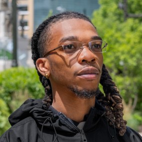 Possible member smiling and looking away from the camera.