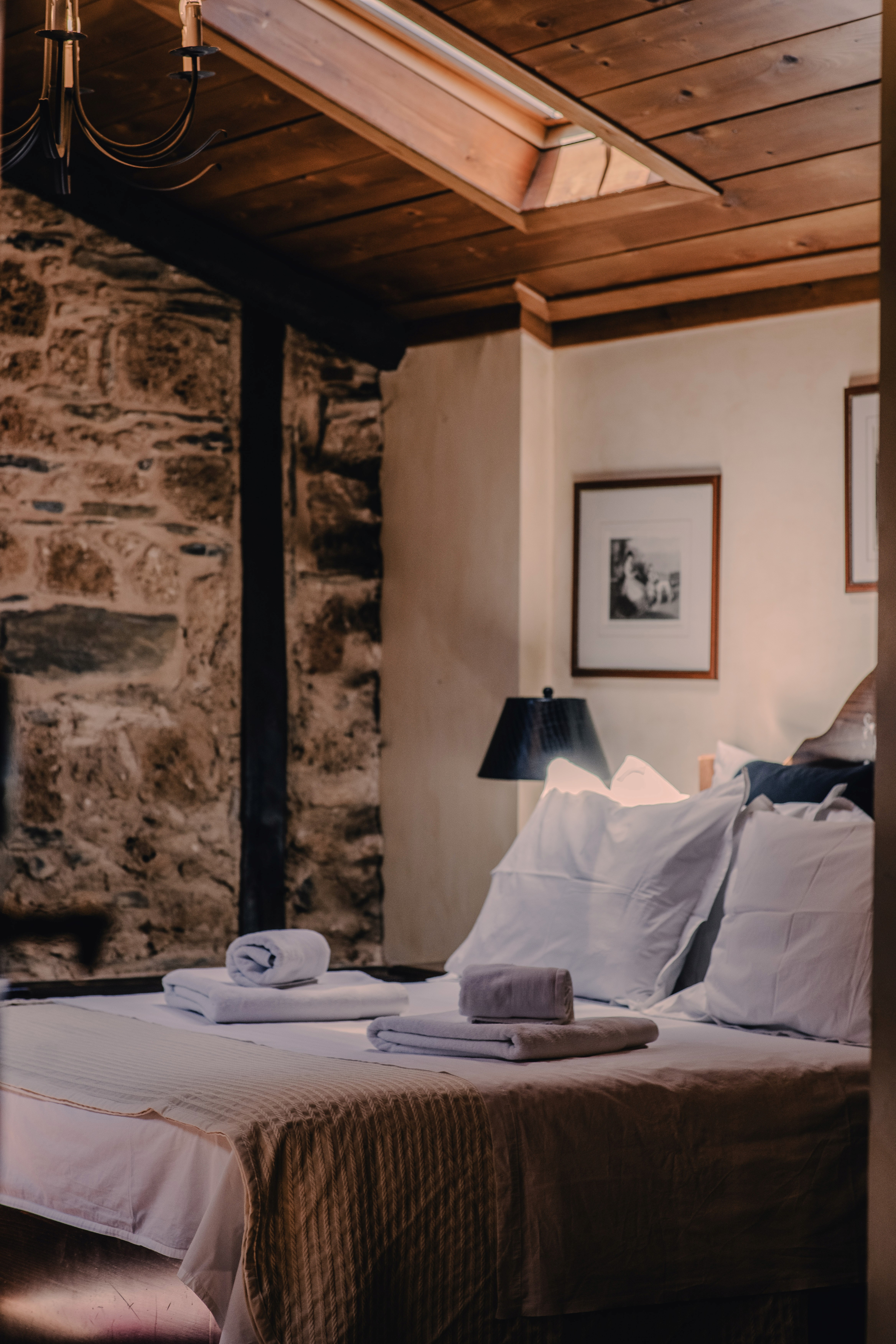 Stone-walled suite with timber ceiling at Palea Poli, boutique hotel in Naousa old town