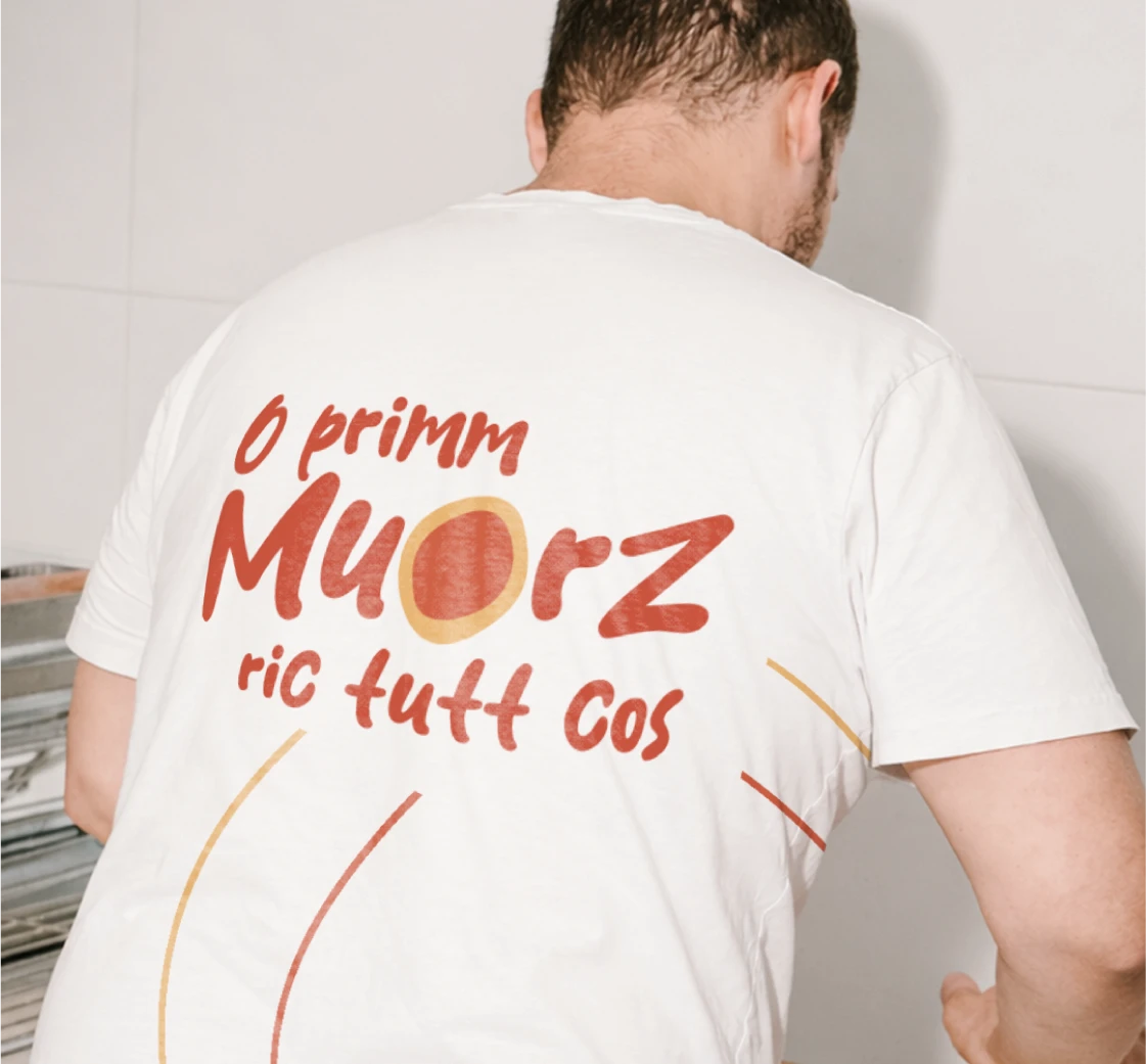Back view of a white Nu Muorz branded T-shirt with red custom lettering and graphic lines.