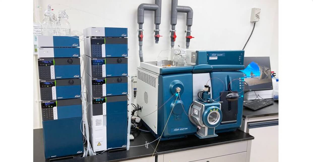 a person in a lab coat working on a computer