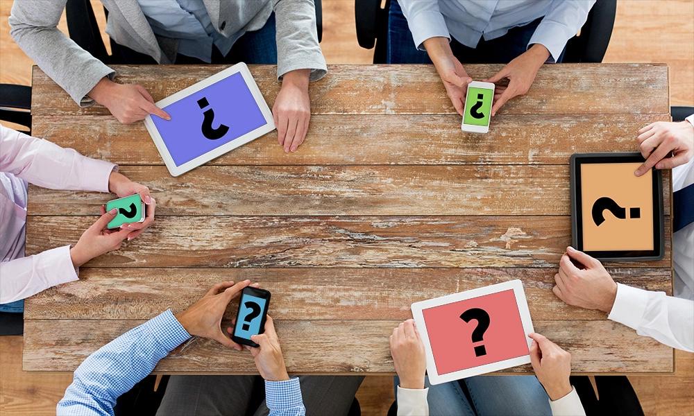 People gathered around a table asking whether SEO or PPC