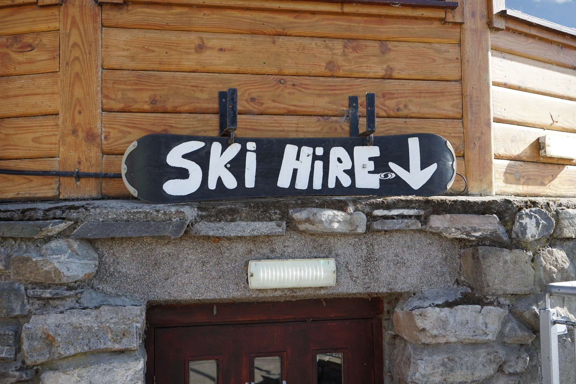 A sign says 'ski hire' above a doorway