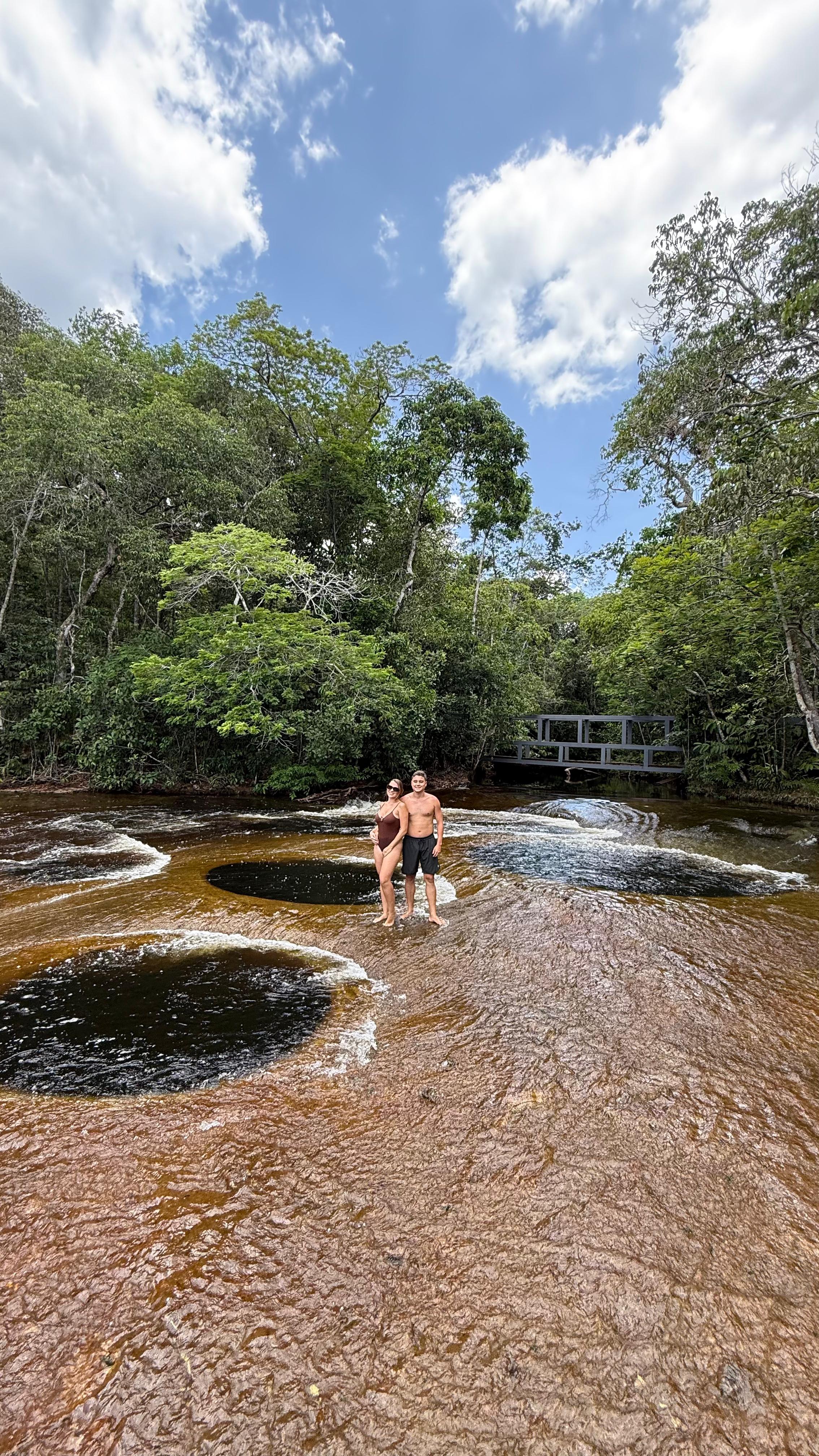 Woman logistics manager using a tablet in a busy warehouse.
