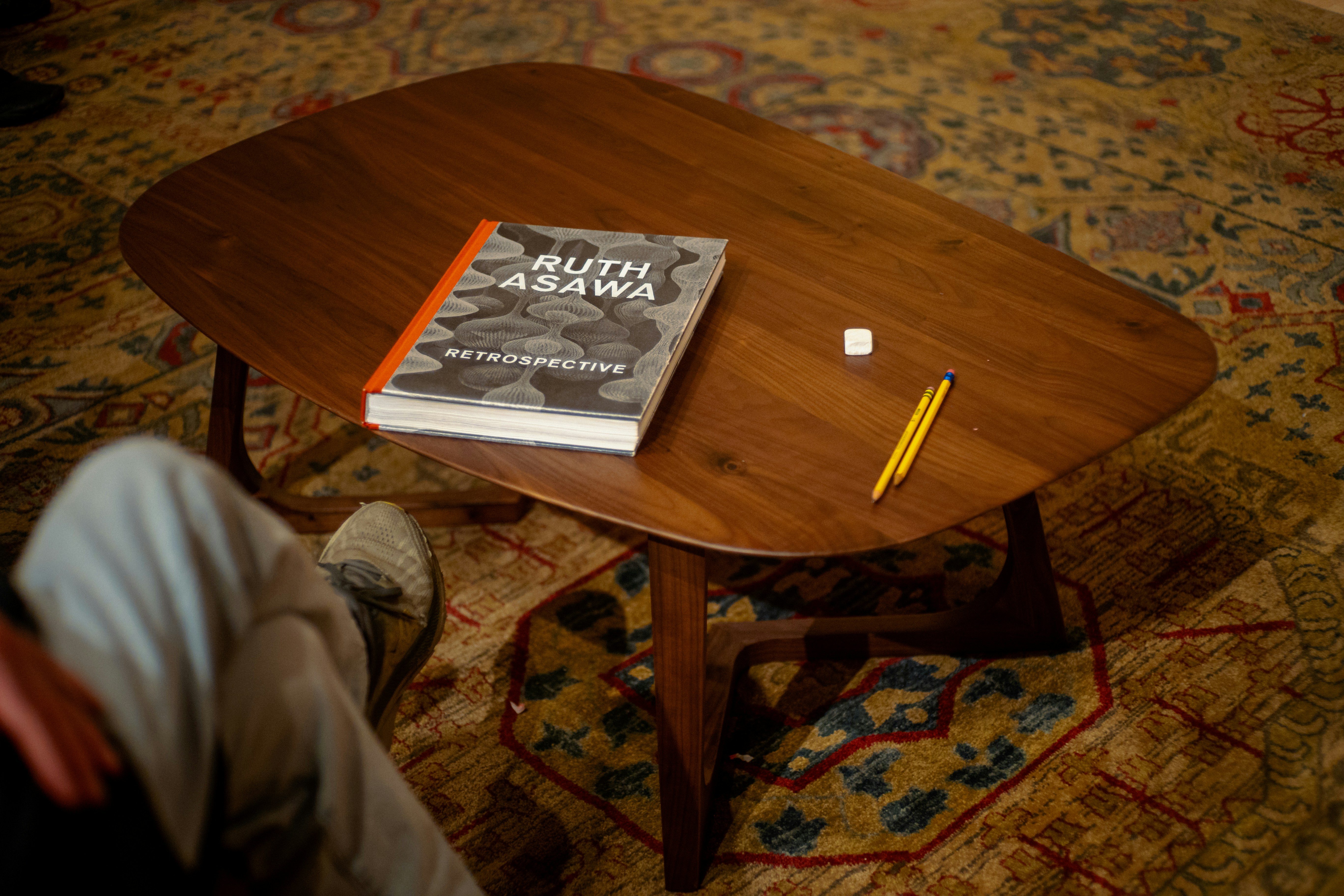 A book, pencil, and eraser rest on a table.