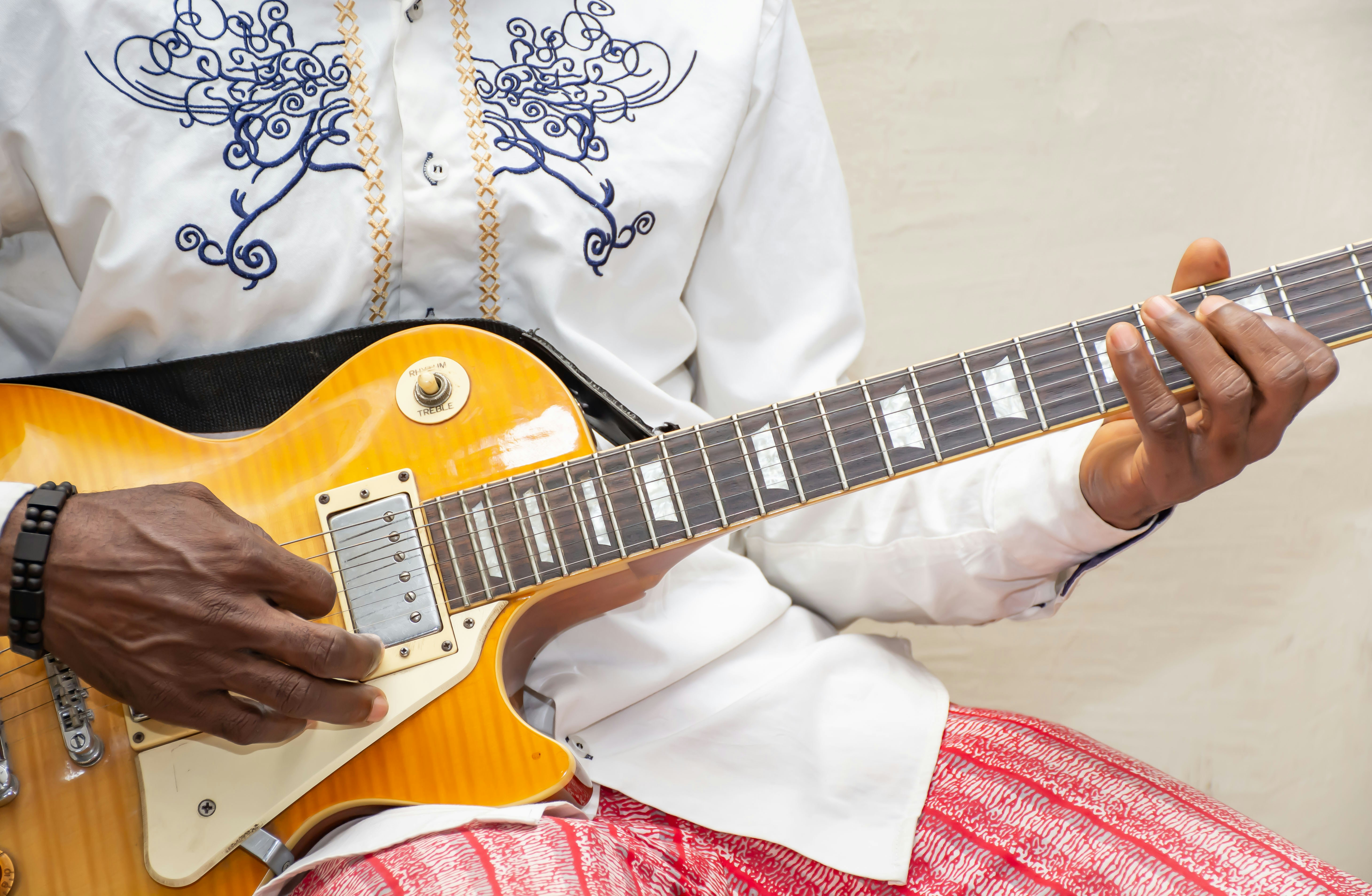 Man fretting a guitar