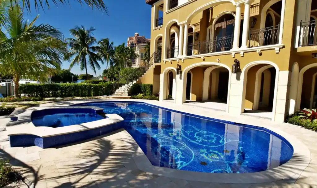 Custom mosaic glass pool with intricate patterns on Naples Bay estate.