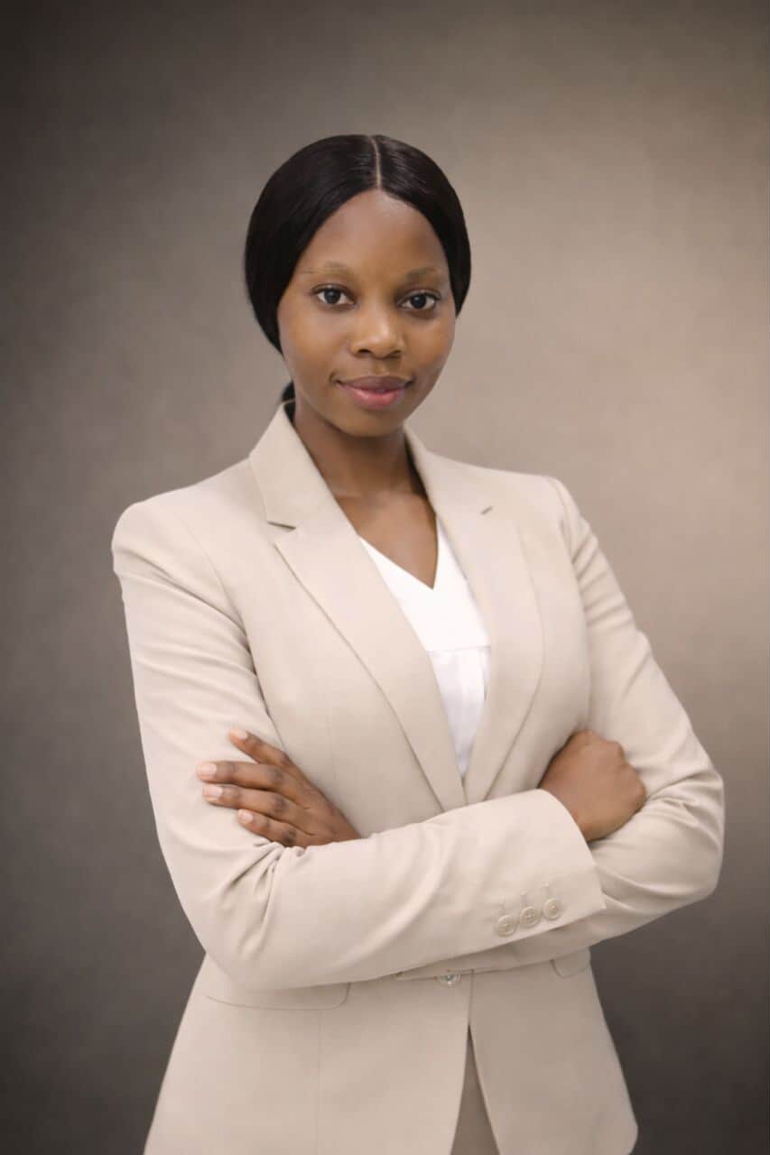 smiling woman sitting on grass during daytime