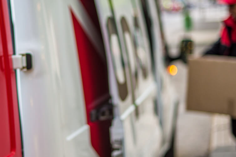 DPD delivery van with courier carrying a package