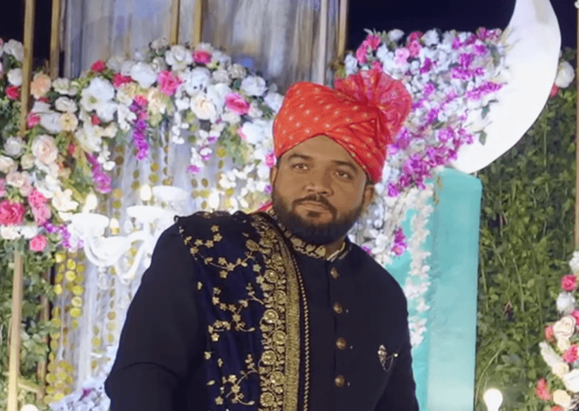 woman in black blazer covering her face with her hand