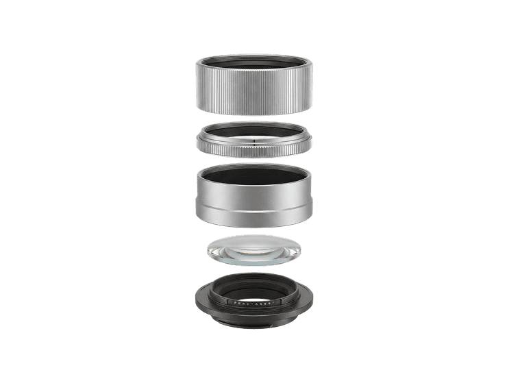 an exploded view of a silver camera lens showing its internal rings and glass elements stacked apart.