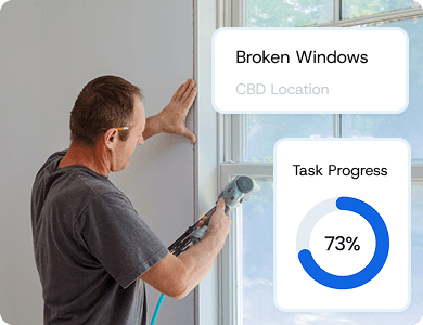 Contractor inspecting a wall with a digital overlay showing task progress at 73%, symbolising real-time job tracking and approvals.