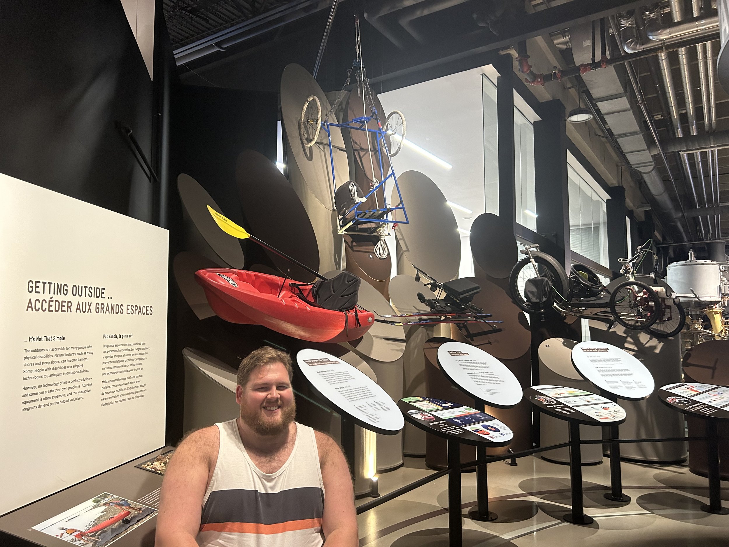 Sam in front of an accessible outdoor exhibit at the Canada Science and Technology Museum