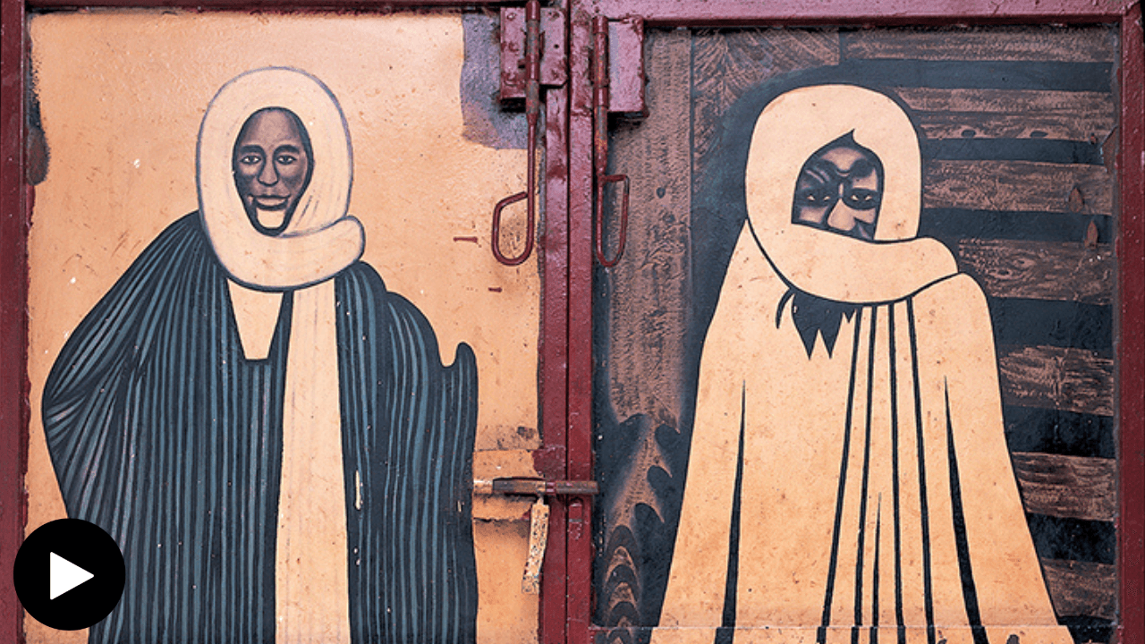 a closeup of the restaurant doors depicitng SImage shows Youssef Carter talking and referencing to the restaurant doors Sheikh Amadou Bamba and Sheikh Ibra Fall.