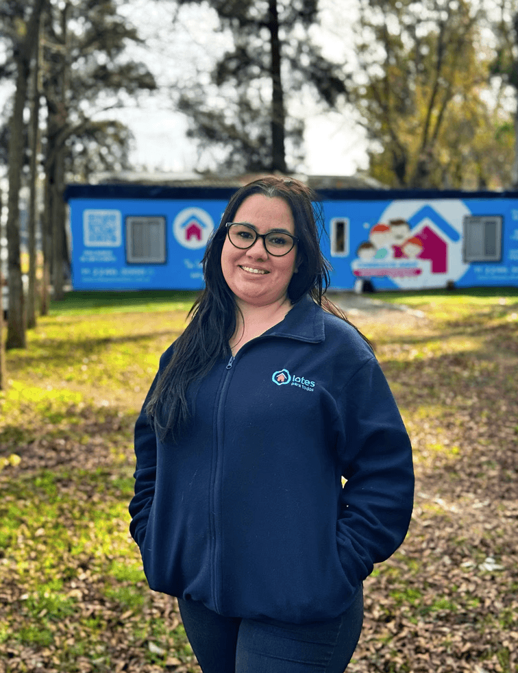 Close-up of a dark green leaf showing its textured surface and central vein against a muted background.