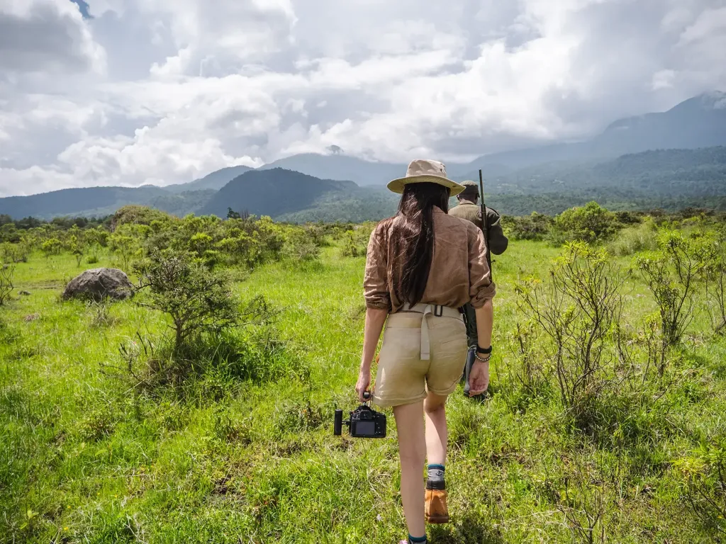 A walking safari group with rangers in Arusha National Park
