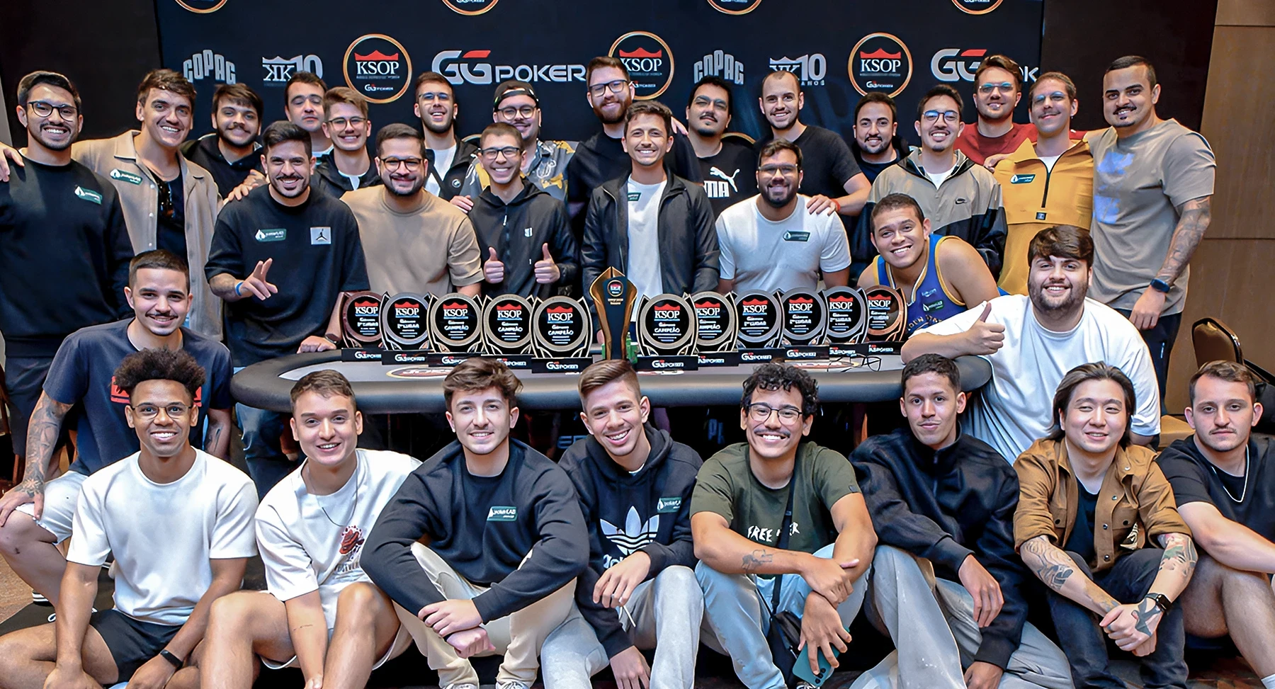 Team of three employees having a meeting at a table in a bright modern office.