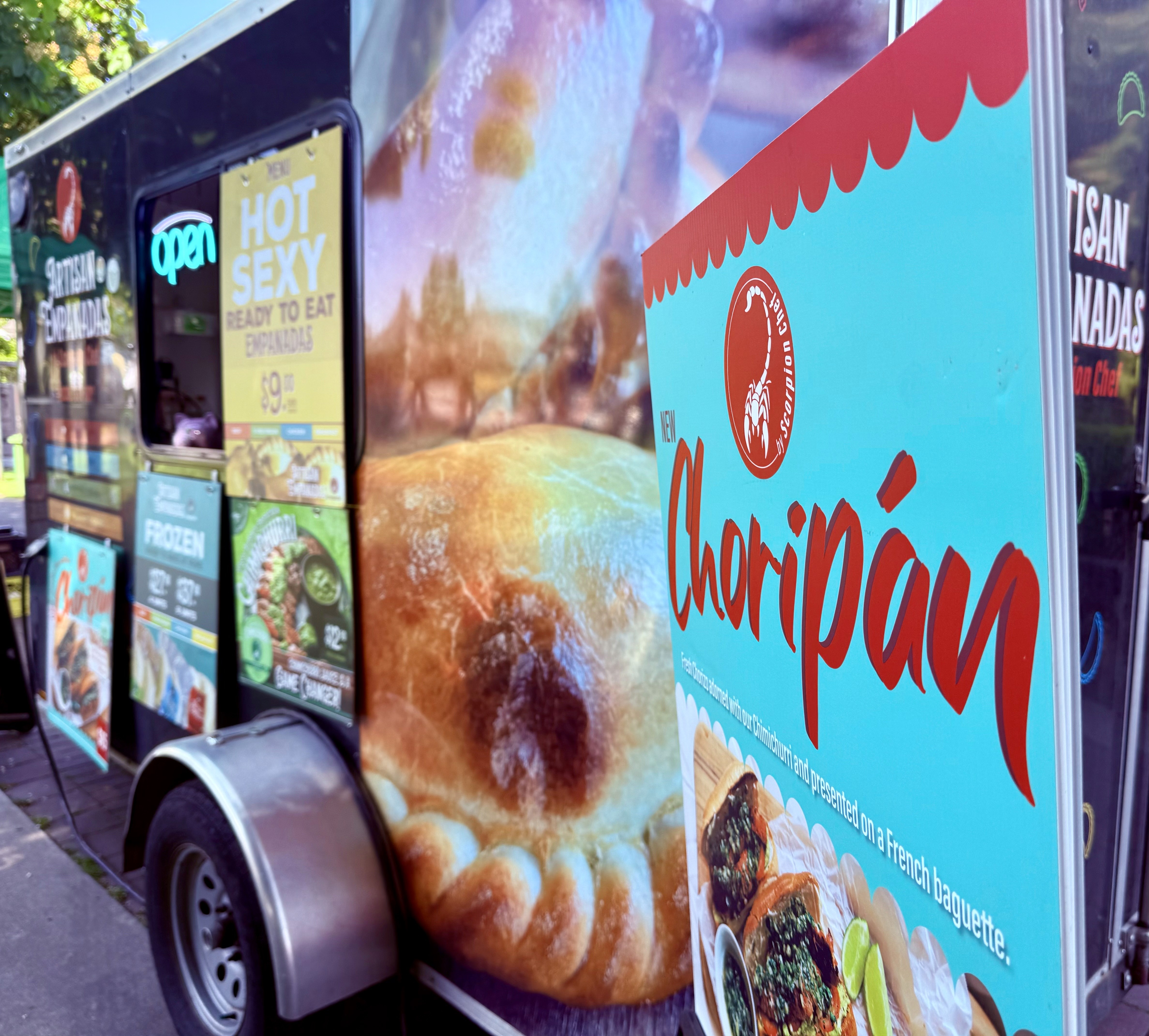 Scorpion Chef artisan empanadas food truck with new choripán sign at Vancouver Island farmer's market BC