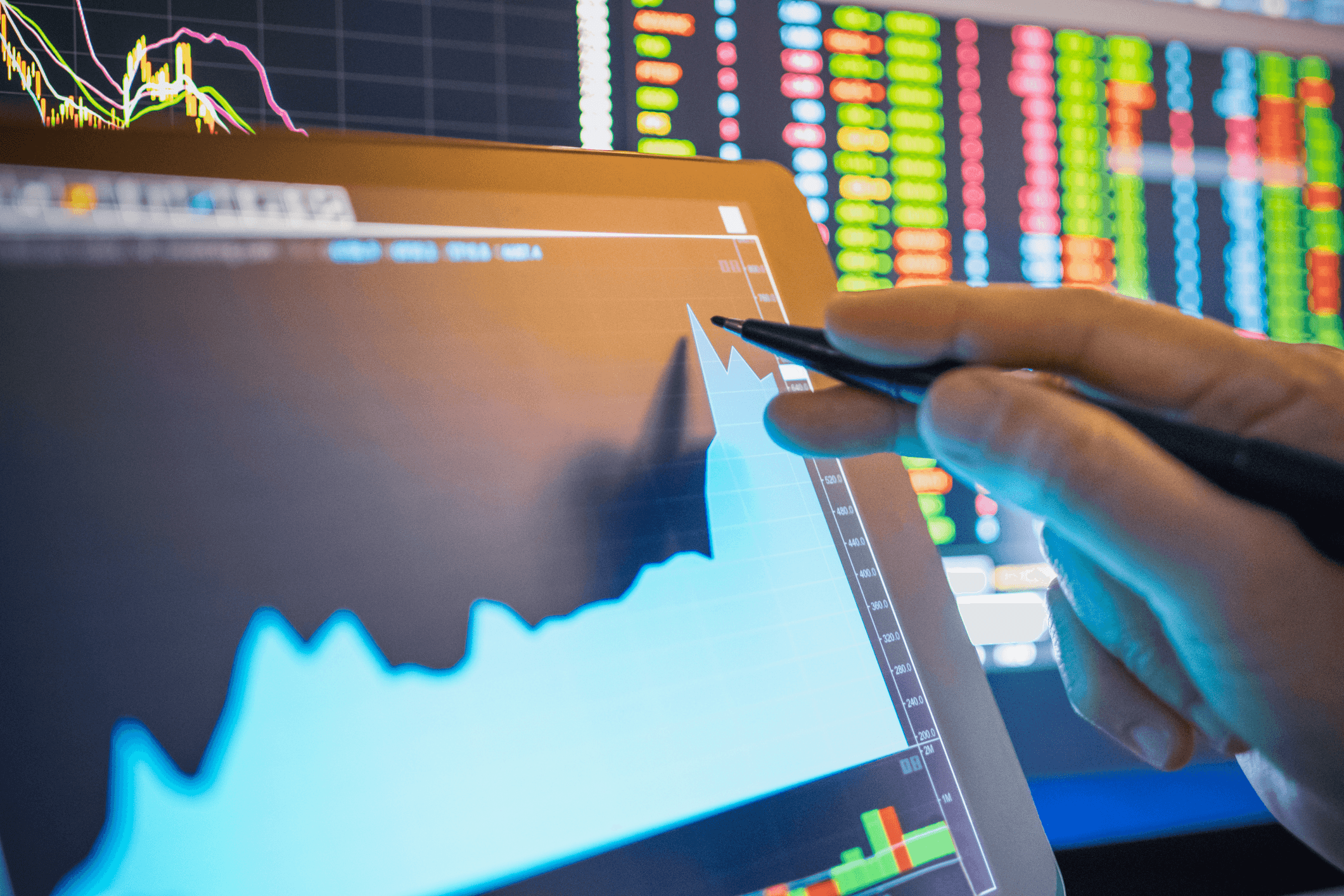 Person analyzing financial growth on digital tablet - How to Invest in Prediction Markets