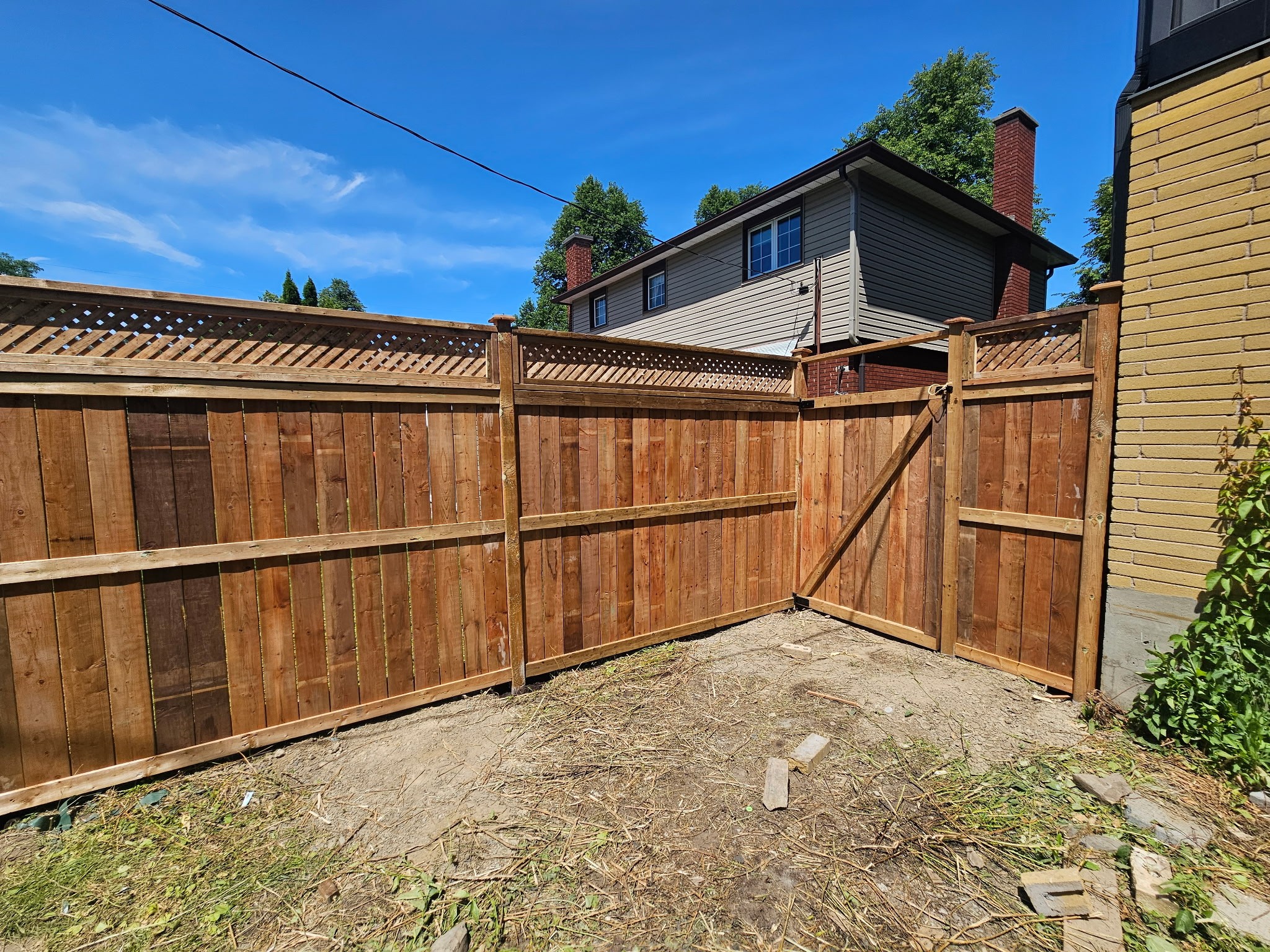 Custom-built wooden backyard deck with outdoor seating and grill.