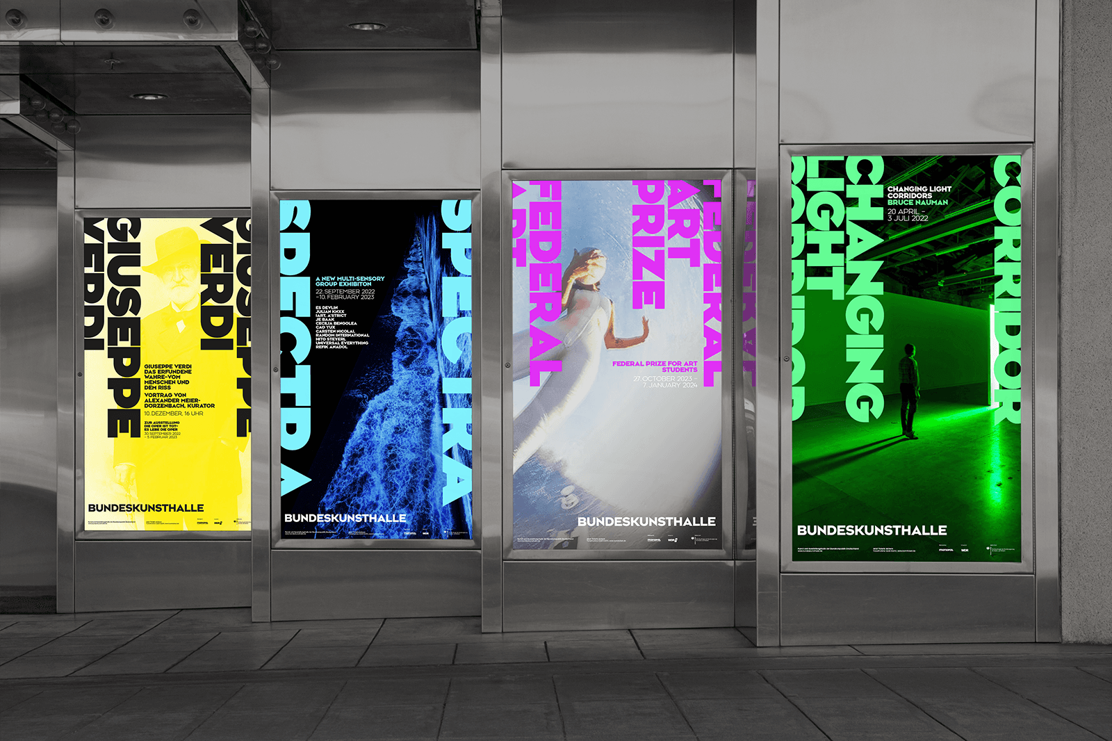 Four colorful digital artworks displayed on walls, featuring vibrant patterns and abstract designs.