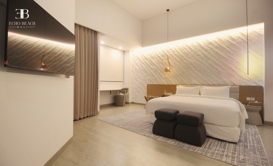 Modern primary bedroom in Bali Canggu Echo Beach Suite apartment, featuring a king bed, ensuite three bathroom, and contemporary lighting.